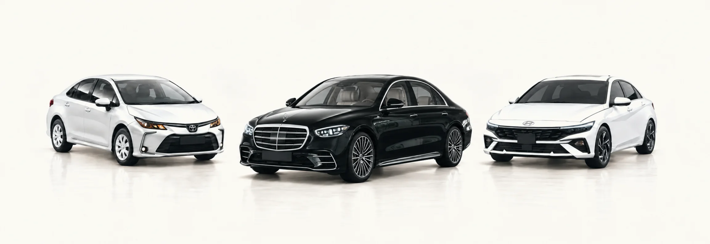 Black Mercedes-Benz S-Class between a white Toyota Corolla and a white Hyundai Elantra in a bright studio