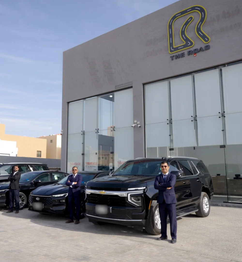 The Road’s branch in Riyadh, with staff standing beside black fleet vehicles